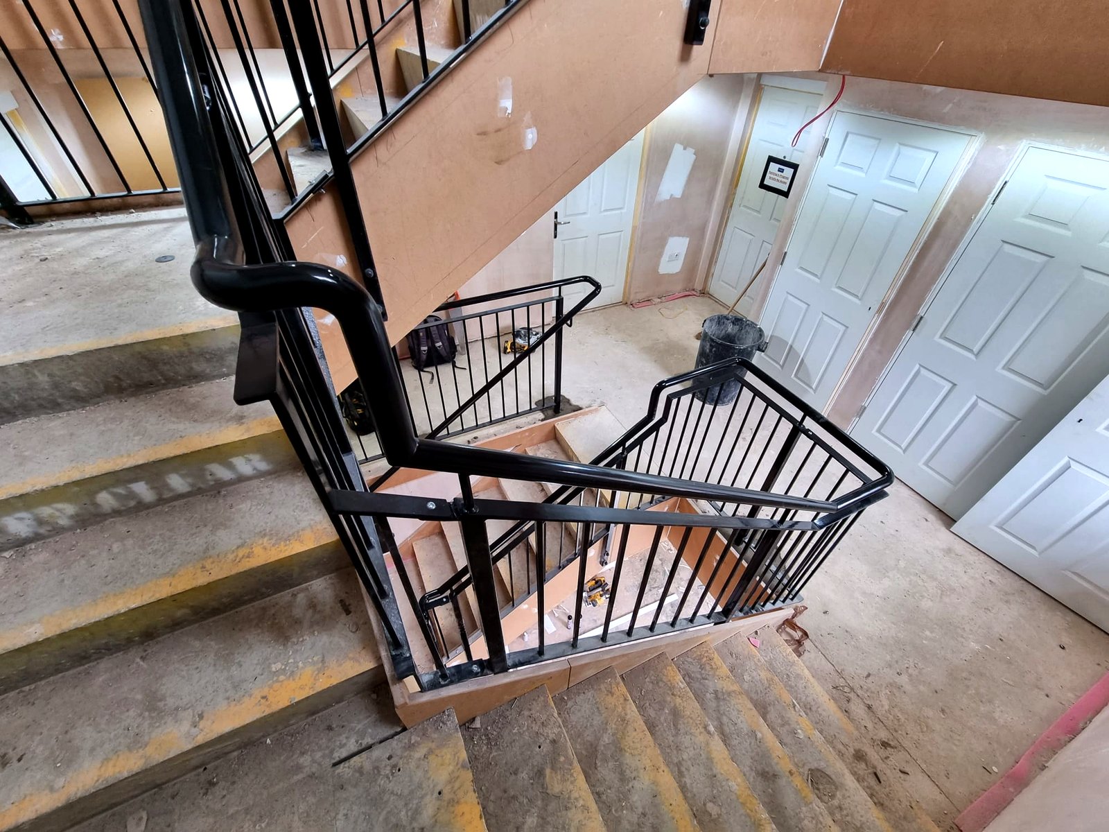 Bespoke metal balustrade and handrail to a communal stairwell landing, Radlett